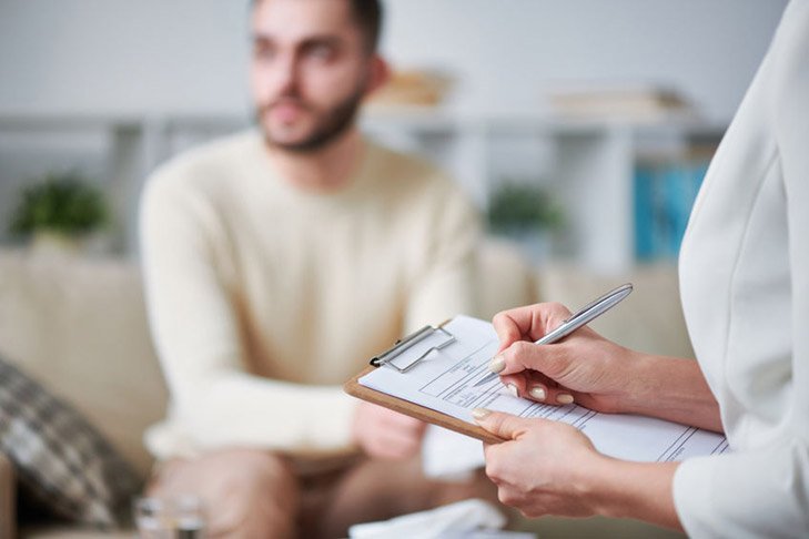 nurse writing down a patients particulars