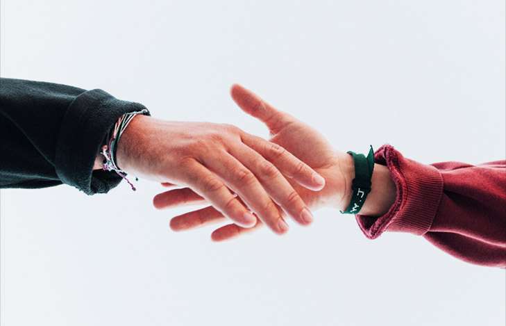 two hands reach out to each other