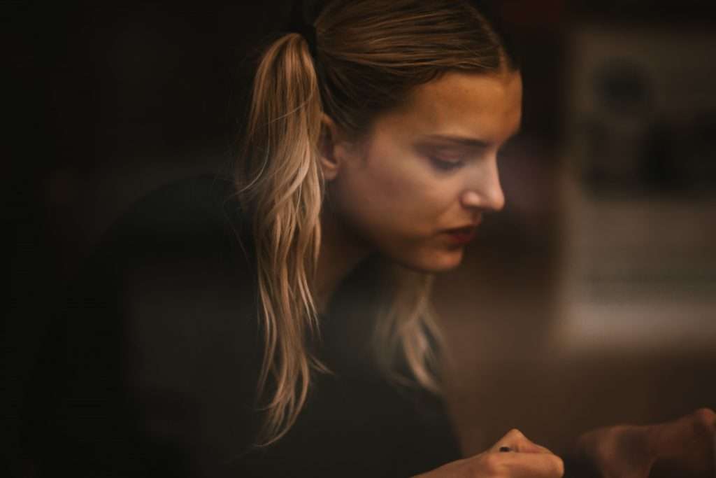 young woman sitting by a window