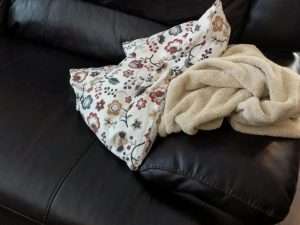 pillow and towel on a leather chair
