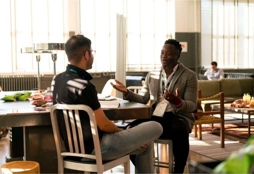 A counselor and rehab treatment program attendee discuss support and ongoing care while having lunch at the cafeteria