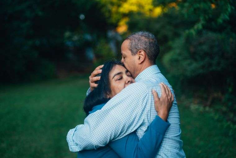 A patient and family member hugging and communicating as part of their recovery
