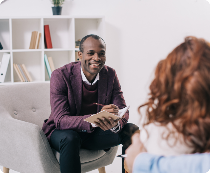 An addiction treatment counselor engaged in conversation about addiction therapy treatment with a client at Cornerstone's Orange County rehab and detox treatment center