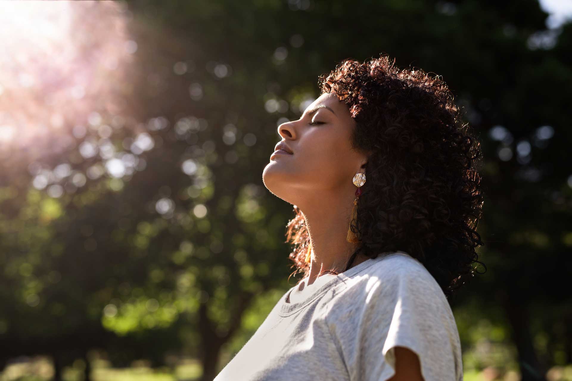 Woman closes eyes while thinking about overcoming drug addiction.